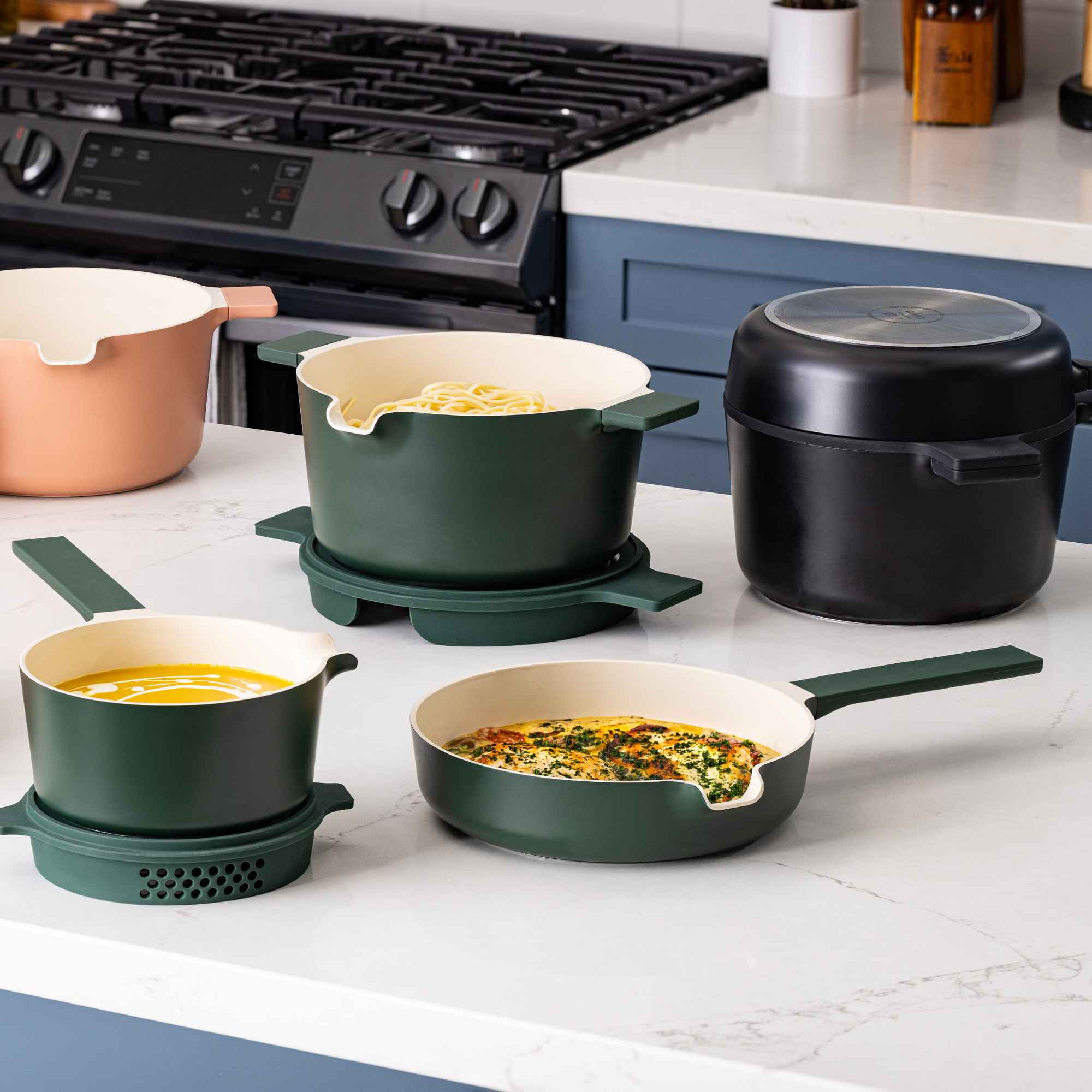 Neat stackable cookware set in use on a kitchen counter with prepared dishes