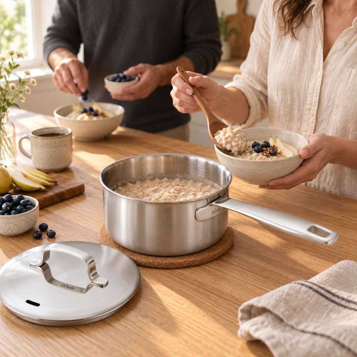 Serving oatmeal with blueberries from an Alva Maestro 5-ply stainless steel saucepan at a breakfast table
