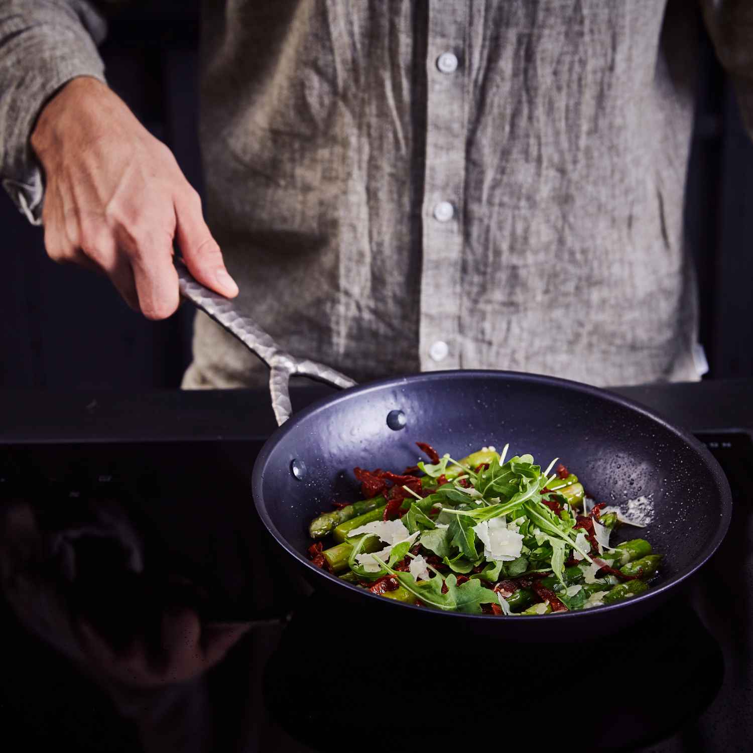Alva Artist carbon steel frying pan serving sautéed greens