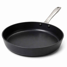 A black non-stick frying pan with a silver metal handle, shown from a three-quarters angle on a white background.