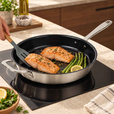 Salmon and asparagus in an Alva Maestro 5-ply nonstick stainless frying pan on an induction cooktop