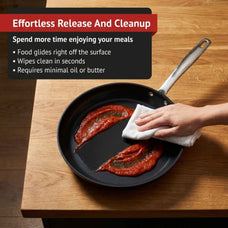 Hand wiping tomato sauce off an Alva Maestro ceramic nonstick frying pan, with callouts for effortless food release and quick cleanup