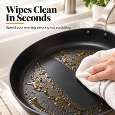 Wiping cooking residue off a Maestro ceramic nonstick frying pan with a towel