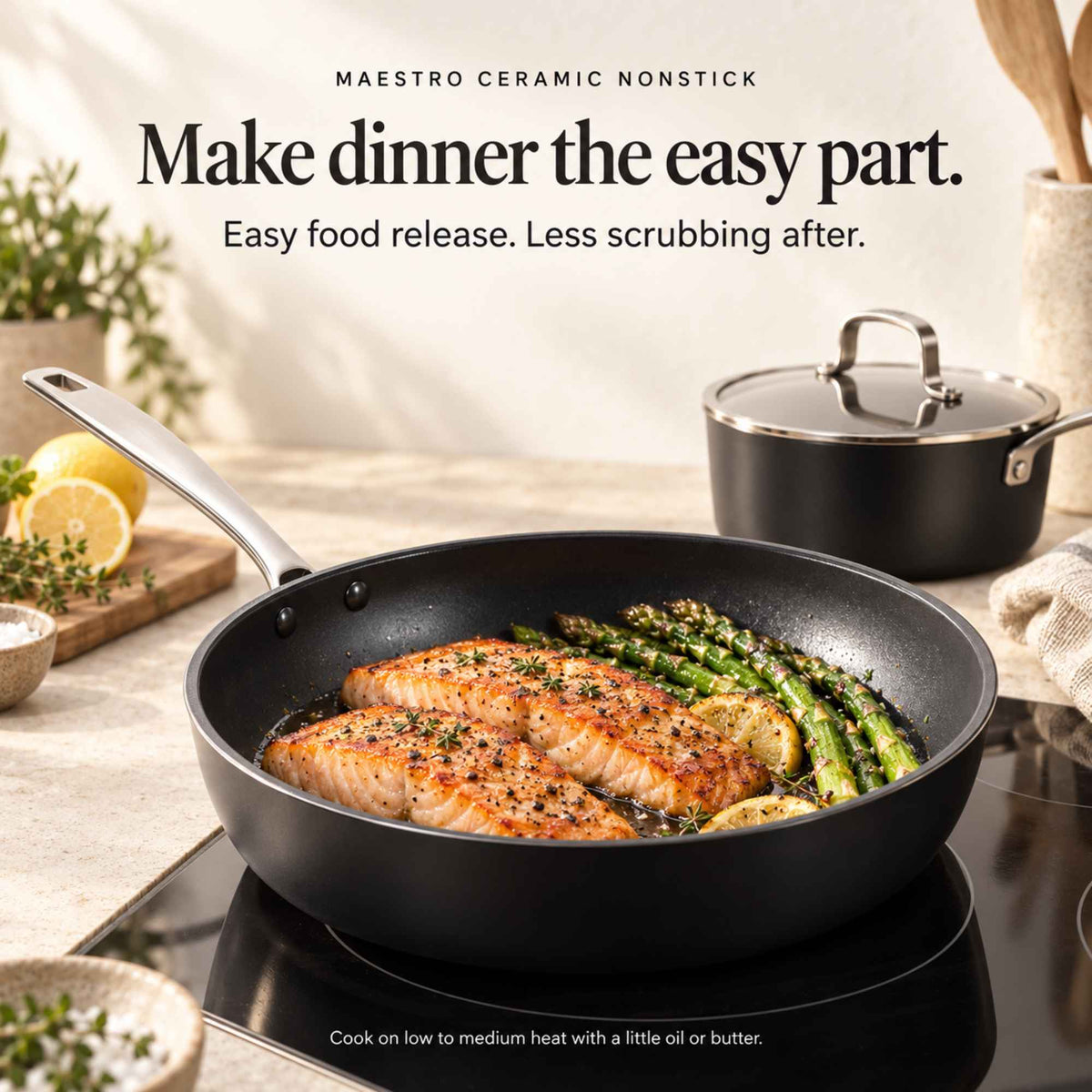 Salmon and asparagus in an Alva Maestro ceramic nonstick frying pan on induction, matching saucepan behind