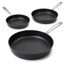 Three Alva Maestro black ceramic nonstick frying pans in graduated sizes on a white background