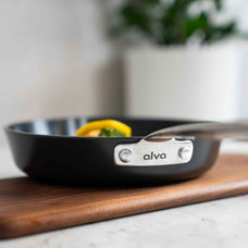 Close-up of the riveted stainless steel handle and alva logo on a Maestro ceramic nonstick frying pan