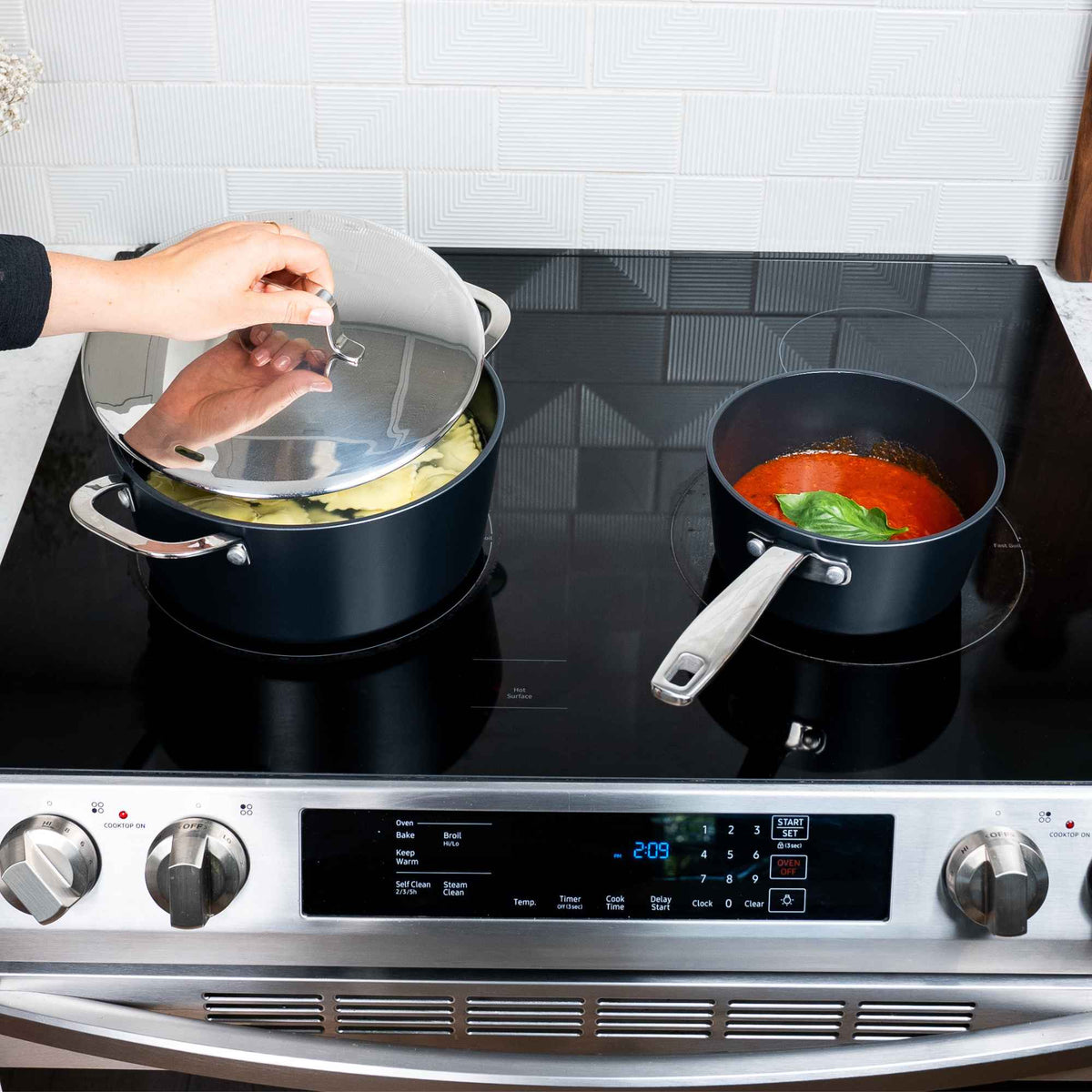 Alva Maestro ceramic nonstick stock pot and saucepan cooking pasta and tomato sauce on an induction range