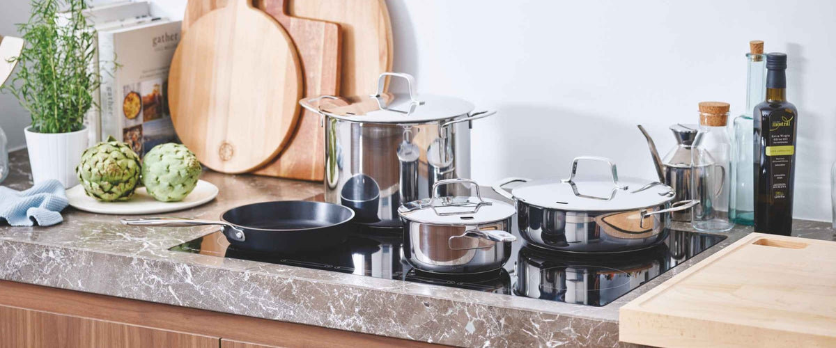 Alva cookware arranged on a kitchen stovetop