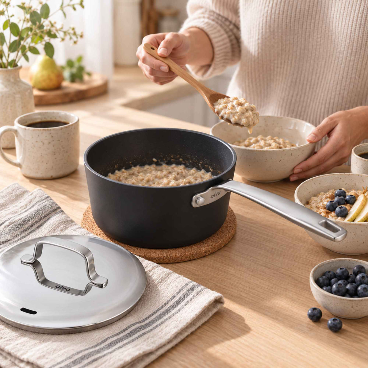 Serving oatmeal with blueberries from an Alva Maestro 2-quart ceramic nonstick saucepan at a breakfast table