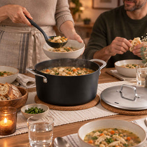 Ladling stew from an Alva Maestro ceramic nonstick stock pot at a family dinner table
