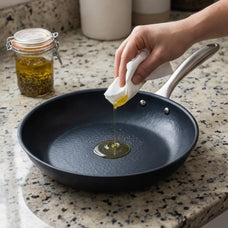 Alva Black Angus carbon steel frying pan being seasoned with oil