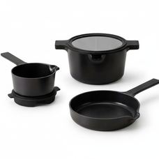 Alva Neat black stackable cookware set arranged on white