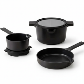 Alva Neat black stackable cookware set arranged on white