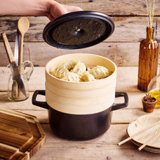 Alva Nori Dutch oven and bamboo steamer serving dumplings